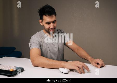 Portrait of happy freelancer male using ergonomic computer mouse with wrist rest for comfort and support, promoting healthy hand and wrist posture Stock Photo