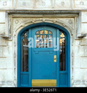 Teal arched doorway with decorative stone surround and brass accents highlighting historic Chicago architecture. Stock Photo