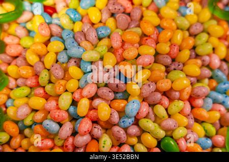 Colorful jelly beans background and candy texture. Close-up of colorful jelly beans piled together, creating a bright candy background for sweets Stock Photo