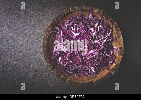 Red cabbage, sliced, in a wooden salad bowl, top view, no people Stock Photo