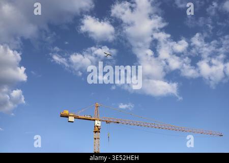 NOWY TARG, POLAND - APRIL 04, 2025: Construction cranes seen against the backdrop of the blue sky. Graphic resources Stock Photo
