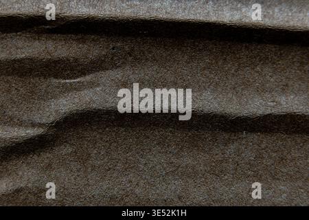 Deep earthy fibrous abstract texture backdrop featuring soft focus organic undulations ideal for design elements and text. Stock Photo