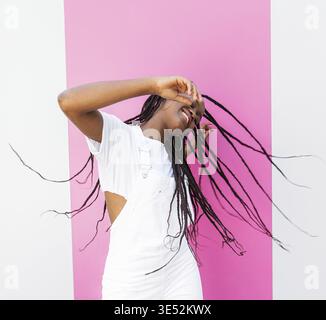Stylish girl in white clothes having fun and dancing Stock Photo