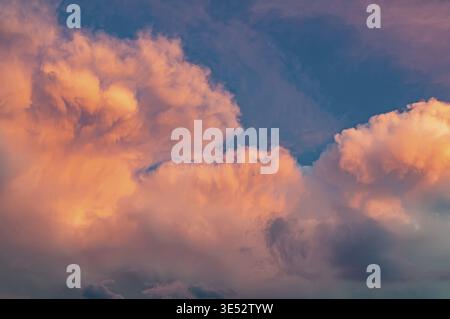Pink clouds at sunset, unusual shape and color of the sky. Background with beautiful and bright sky Stock Photo