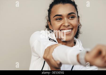 Close up of smiling sports woman warming up her hand before training Stock Photo