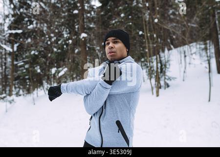 Man doing stretching exercise in a park Stock Photo