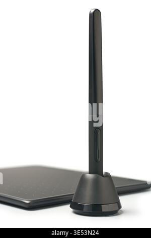 black digital stylus pen in circular base holder with graphics tablet isolated white background, matte plastic finish input device, side view Stock Photo