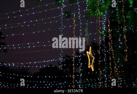 Decorative Outdoor Christmas Fairy Lights with Hanging Star Ornament at Night Stock Photo