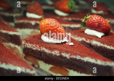 Red velvet cake slices with strawberries on top Stock Photo