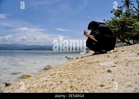 Taking Photos of Objects on the Beach Shore on a Bright Sunny Day Stock Photo