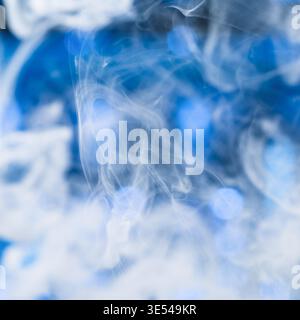 abstract white smoke on blue background soft flowing vapor texture Stock Photo