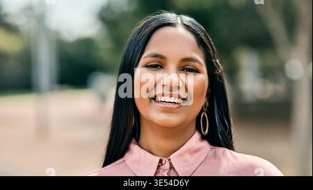 Portrait, confident or businesswoman with smile in park, sustainability or eco conservation advocate. Pride, happy or environmental lawyer with green Stock Photo