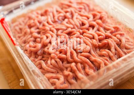 Minced meat in a plastic big container from the supermarket Stock Photo