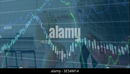 Displaying transparent financial chart overlay covering meeting room, showing laptop, blazers, pens Stock Photo