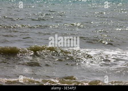 Sunlight sparkling on dark rippling Mediterranean sea water Stock Photo