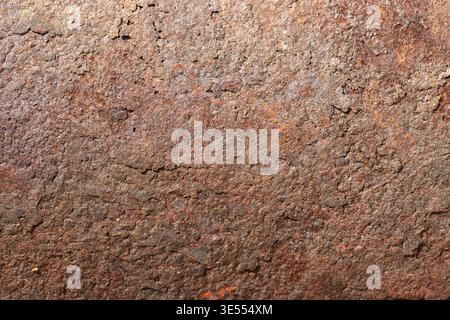 Rusty metal surface. Industrial aged wall with corrosion patterns. Surface of metal wall displaying granular rust formation with pitted texture Stock Photo