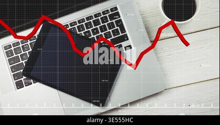 Displaying silver laptop with black tablet diagonally on white desk, coffee cup, red trend overlay Stock Photo