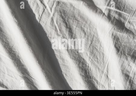 White fabric surface showing soft folds and wrinkles with natural light Stock Photo
