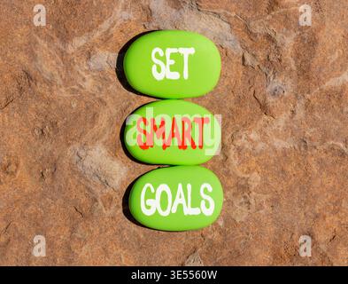Set smart goals words symbol. Concept words Set smart goals on beautiful green stones. Beautiful stone beach background. Business and set smart goals Stock Photo