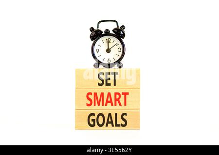 Set smart goals words symbol. Concept words Set smart goals on beautiful wooden blocks. Beautiful white background. Black alarm clock. Business and se Stock Photo