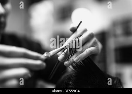 Precise Grooming Skills. Skillful Barber Shaping Hair. Closeup Of Barber Using Scissors Carefully Stock Photo