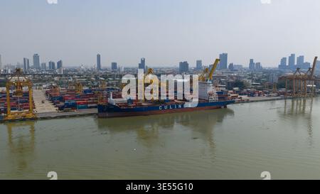 Bangkok, Thailand - 05 February 2026: Aerial view of Bangkok Port with a large container ship docked alongside yellow cranes and stacked containers ag Stock Photo