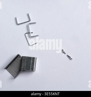 isolated staples on a white surface Stock Photo