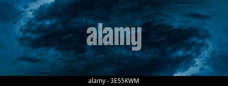 Dark blue cloudy sky before thunderstorm. Storm gloomy heaven cloudscape. Nature dramatic skyscape wide banner background Stock Photo