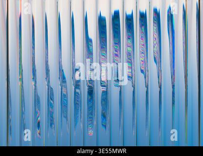 3D rendering of an abstract composition featuring Liquid Glass vertical tubes arranged in a clean repeating structure. Stock Photo