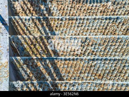 old, blue, rusty stairs going down Stock Photo