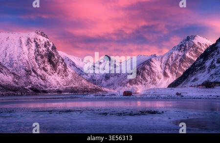 Beautiful snow covered mountains and purple sky with pink clouds Stock Photo
