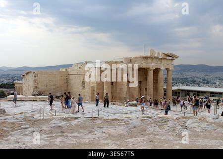 Tourists around Propylaea Monumental Entrance Gate August 2024 Classical greek stone columns and ruins Athens Greece Stock Photo