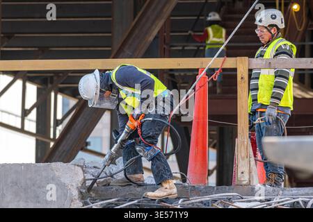 Raleigh, North Carolina, USA : A construction worker uses a jackhammer to break concrete at the North Carolina Education Campus construction site. Stock Photo
