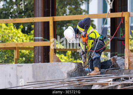 Raleigh, North Carolina, USA : A construction worker uses a jackhammer to break concrete at the North Carolina Education Campus construction site. Stock Photo