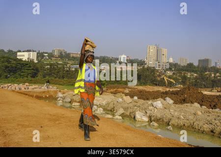 Worker carrying blocks on construction site in Kigali, Rwanda Stock Photo