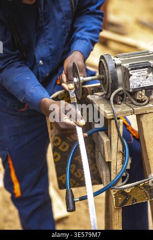 Worker in a carpentry workshop in Kigali, Rwanda Stock Photo