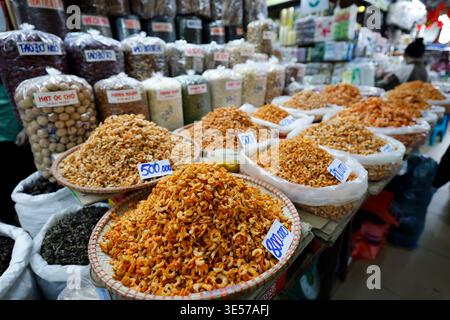 Large wicker baskets heaped with dried shrimp sold in bulk at a Vietnamese market. Hanoi. Vietnam. Stock Photo
