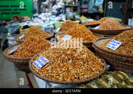 Large wicker baskets heaped with dried shrimp sold in bulk at a Vietnamese market. Hanoi. Vietnam. Stock Photo