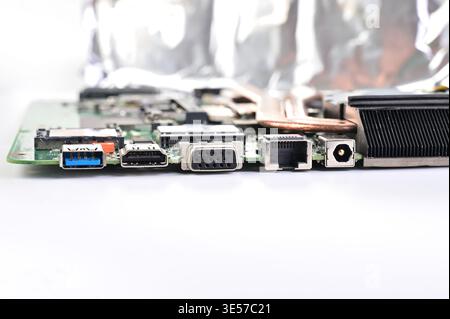 Close-up view of a computer motherboard with various ports and connectors on a white background Stock Photo