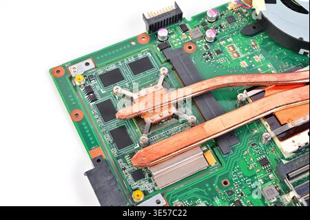 Close-up view of a laptop motherboard with copper heat pipes and components Stock Photo