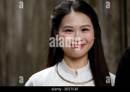 Close-up portrait of a beautiful smiling young Vietnamese woman wearing white ao dai dress. Hanoi. Vietnam. Stock Photo