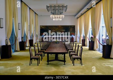 Formal dining room with long wooden table inside Reunification Palace. Ho Chi Minh city. Vietnam. Stock Photo
