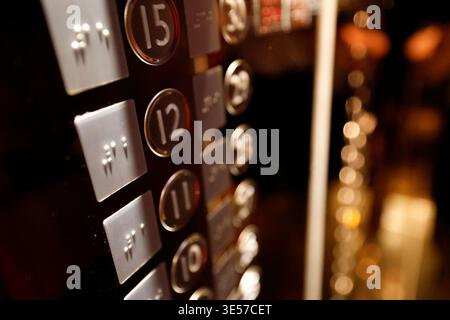 Modern lift control panel featuring Braille accessibility buttons alongside numbered floor selection buttons.  Vietnam. Stock Photo