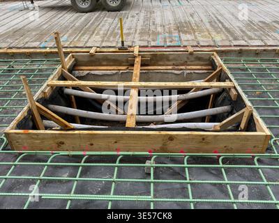 Denver, Colorado, USA - 2 June 2025: Wire framework installed for laying reinforced concrete on an access road in a city centre. Stock Photo