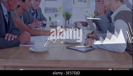 Leaning six team members in businesswear discussing charts in office tapping tablet reviewing data Stock Photo