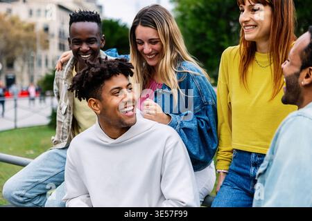 Happy young group of diverse friends having fun together outdoor Stock Photo