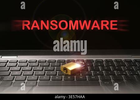 Computer security concept with a closed padlock on the laptop keyboard and "Ransomware" text on the screen. Cyber threat concept image. Stock Photo