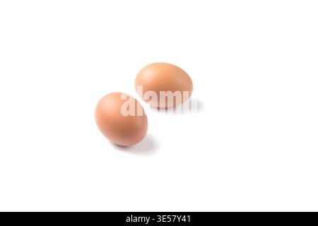Two brown-shelled eggs. Fresh eggs on a white Stock Photo