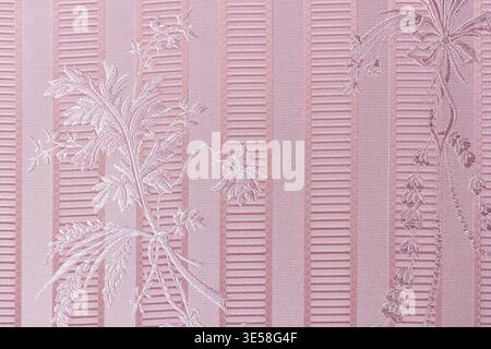 Soft pink jacquard fabric featuring embossed floral motifs and alternating textured stripes, ideal for vintage-inspired upholstery, curtains, wallpape Stock Photo