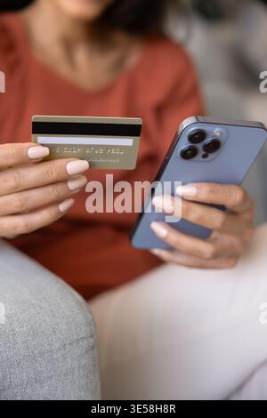 Close up female hands holding credit card and phone Stock Photo
